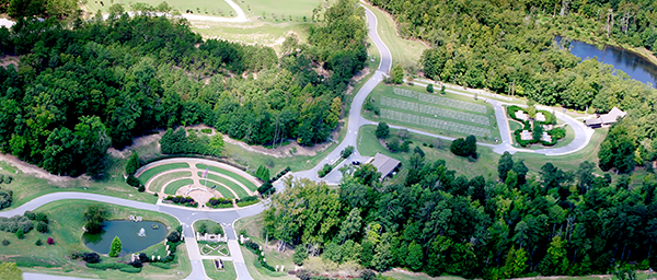 An aerial photo of GVMC-Milledgeville shows a large gathering area around 3 flag staffs, an administration building, the first phase of burials, and a commital shelter. 