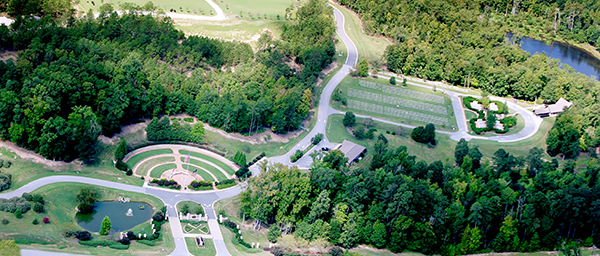 An aerial photo of GVMC-Milledgeville shows a large gathering area around 3 flag staffs, an administration building, the first phase of burials, and a commital shelter.